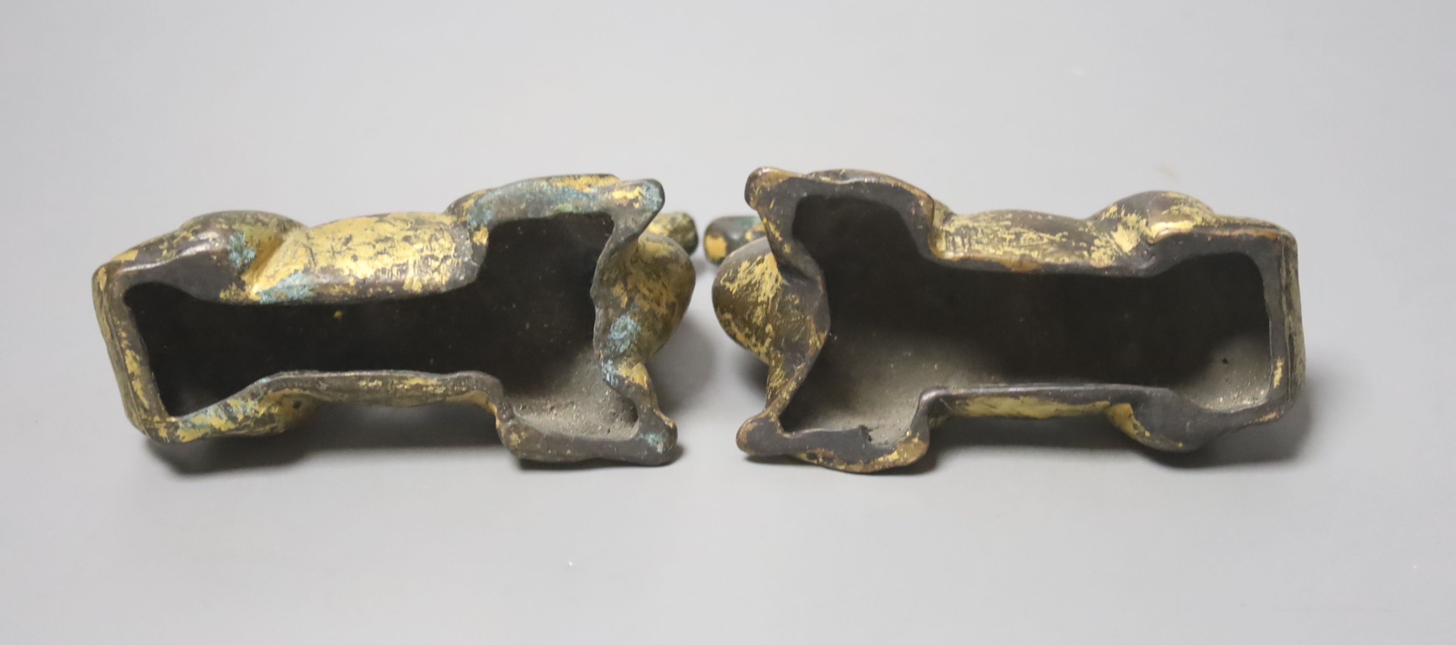 A pair of Chinese gilt bronze scroll weights, modelled as resting camels, 10cm long